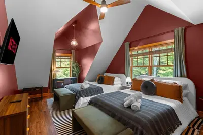 two beds in a room with red walls at Luxury Chalet, Firepit, Sauna, Pet Friendly, 5 mins to Windham Mtn resort in Windham