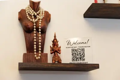 a wooden statue of a god with a pearl necklace at 3 Bedroom Gem! King, Full & Twin Beds, Sauna with Free Parking plus more in Jersey City