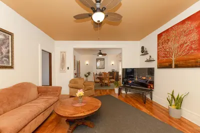 a living room with a couch and a table at 3 Bedroom Gem! King, Full & Twin Beds, Sauna with Free Parking plus more in Jersey City