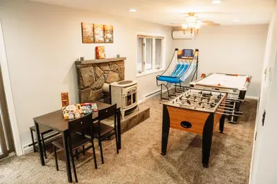 a living room with a table and a pool table at Hunter Haven - Luxury Cabin Near Mountain Ski Resort in Lanesville