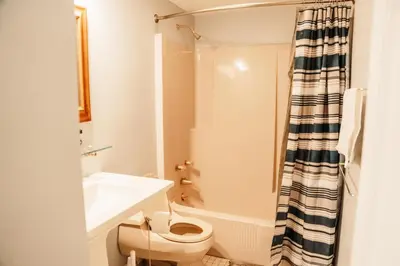 a bathroom with a toilet and a sink and a shower at Hunter Haven - Luxury Cabin Near Mountain Ski Resort in Lanesville