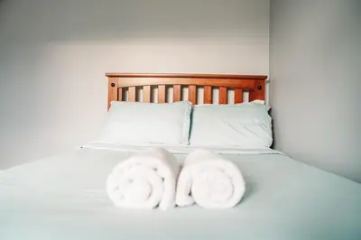 two towels are sitting on a bed at Hunter Haven - Luxury Cabin Near Mountain Ski Resort in Lanesville