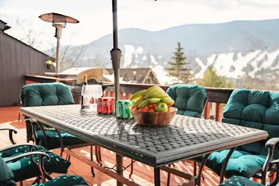 a bowl of fruit on a table on a balcony at Hunter Haven - Luxury Cabin Near Mountain Ski Resort in Lanesville