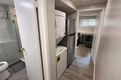 a small kitchen with a refrigerator and a toilet at 2 Bd 2 Ba Unit laundry &kitchen in Great Neck