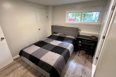 a bedroom with a bed and a desk and a window at 2 Bd 2 Ba Unit laundry &kitchen in Great Neck