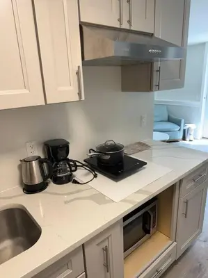a kitchen with two pots and pans on the counter at 2 Bd 2 Ba Unit laundry &kitchen in Great Neck