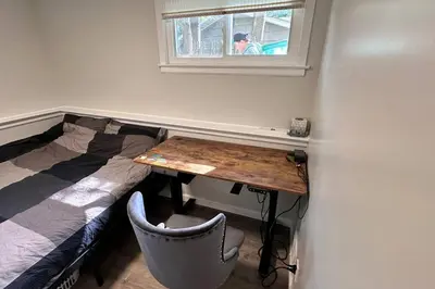 a room with a desk and a bed and a table at 2 Bd 2 Ba Unit laundry &kitchen in Great Neck