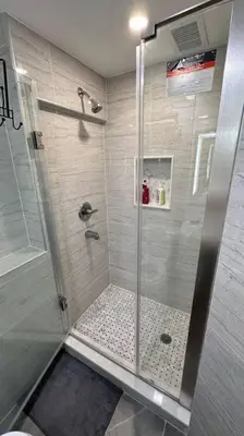 a shower with a glass door in a bathroom at 2 Bd 2 Ba Unit laundry &kitchen in Great Neck