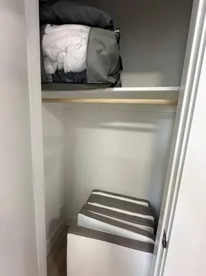 a small closet with a bed and a mattress at Comfy NJ 2BR Close to Airport, Dream Mall & NYC in East Newark