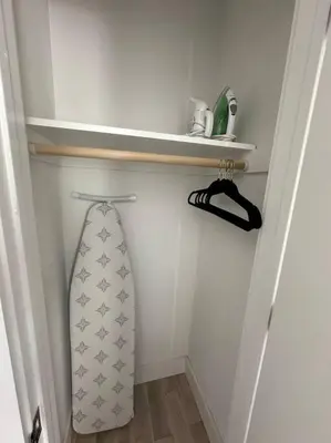 a surfboard hanging on a shelf in a room at Comfy NJ 2BR Close to Airport, Dream Mall & NYC in East Newark