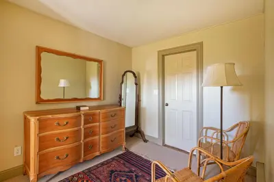 a bedroom with a dresser and a mirror at ABC Stay - Connecticut Five Bedroom Home in Warren