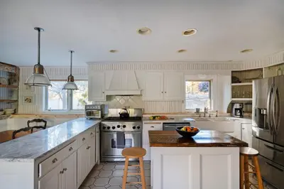 a kitchen with white cabinets and a counter top at ABC Stay - Connecticut Five Bedroom Home in Warren