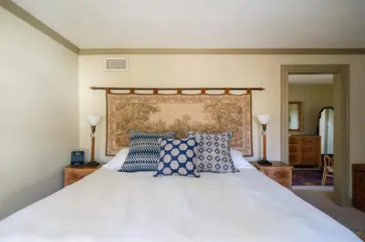 a bedroom with a white bed with blue pillows at ABC Stay - Connecticut Five Bedroom Home in Warren
