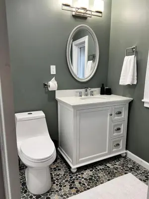 a bathroom with a white toilet and a mirror at 7BR Spacious Property Perfect For up to 15! in Orange