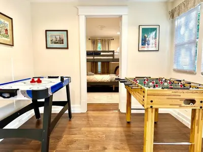 a living room with a table and a foos ball at Family Lake House Waterfront in Saugerties