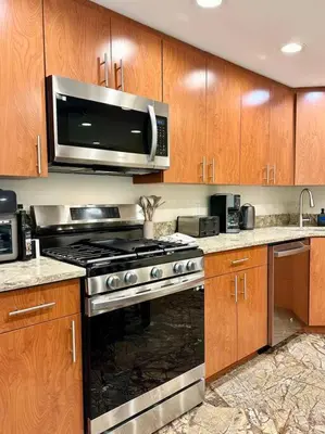 a kitchen with a stove and a microwave at Family Lake House Waterfront in Saugerties