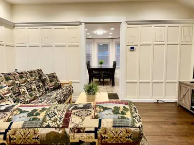 a living room with a couch and a table in it at Family Lake House Waterfront in Saugerties