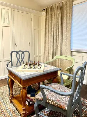 a chess board on a table with two chairs at Family Lake House Waterfront in Saugerties