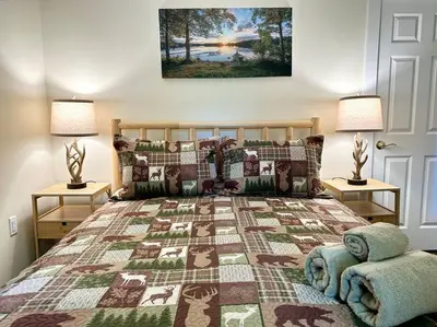 a bedroom with a large bed with two lamps at Family Lake House Waterfront in Saugerties