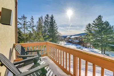a balcony with two chairs and a view of the snow at Bearfoot Apres Mtn-View Condo Less Than 1 Mi to Mt Snow! in Podunk