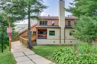 a house with a wooden walkway in front of it at Bearfoot Apres Mtn-View Condo Less Than 1 Mi to Mt Snow! in Podunk