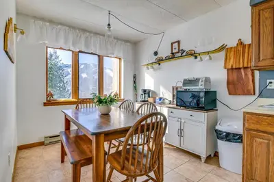 a kitchen with a wooden table and chairs at Bearfoot Apres Mtn-View Condo Less Than 1 Mi to Mt Snow! in Podunk