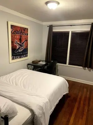 a bedroom with a bed and a desk and a window at New Quaint & Convenient Hideaway Great Location in East Hartford