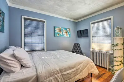 a bedroom with blue walls and a bed and two windows at New Quaint & Convenient Hideaway Great Location in East Hartford