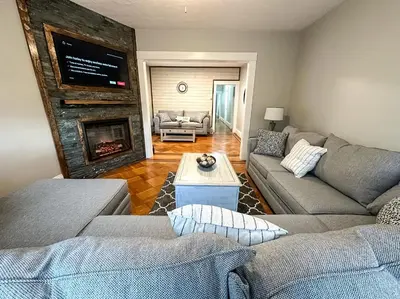 a living room with two couches and a fireplace at The Allen House - 3 Bedroom - 2 Full Bath - Private Gorgeous Apartment - Sleeps 8 in Albany