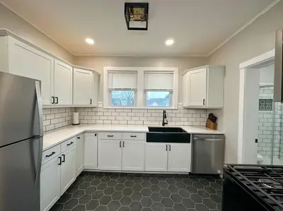 a kitchen with white cabinets and a sink at The Allen House - 3 Bedroom - 2 Full Bath - Private Gorgeous Apartment - Sleeps 8 in Albany