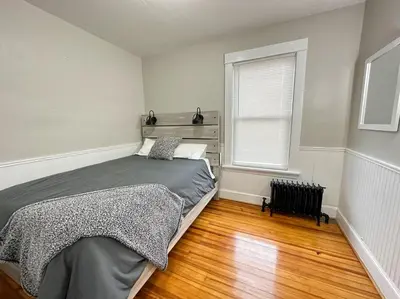 a bedroom with a bed and a window at The Allen House - 3 Bedroom - 2 Full Bath - Private Gorgeous Apartment - Sleeps 8 in Albany