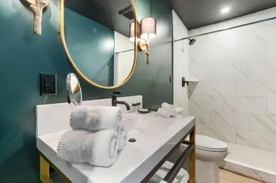 a bathroom with a sink and a mirror and a toilet at Inn At Mount Snow in West Dover