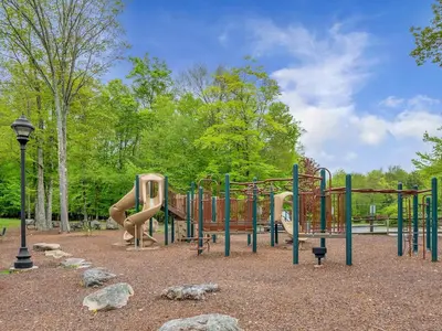 a playground with a slide in a park at Winter Hideaway - Sled Hill, Hot Tub, Fireplace, Game Room in Gouldsboro