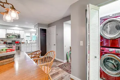 a kitchen and dining room with a table and a washing machine at Home with Private Dock Near Colgate University in Hamilton