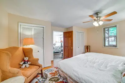 a bedroom with a bed and a teddy bear in a chair at Home with Private Dock Near Colgate University in Hamilton