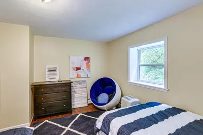 a bedroom with a bed and a dresser and a window at Home with Private Dock Near Colgate University in Hamilton