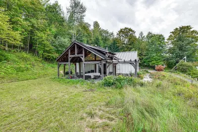a small house in the middle of a field at Home with Private Dock Near Colgate University in Hamilton