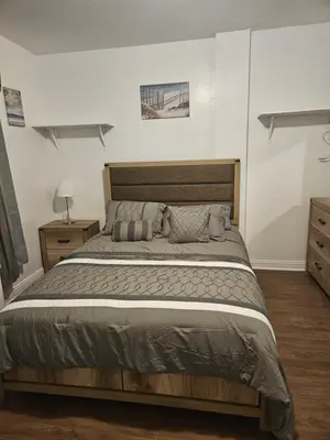 a bedroom with a large bed in a room at Cozy Zone in Williams Bridge