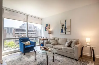 a living room with a couch and a table at Modern Apt Close to Downtown in Stamford