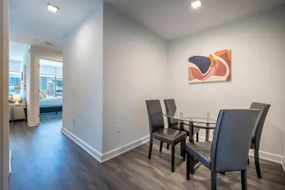 a dining room with a table and chairs at Modern Apt Close to Downtown in Stamford