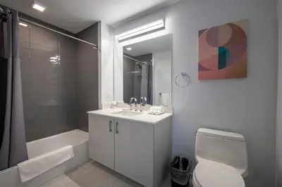 a bathroom with a sink and a toilet and a shower at Modern Apt Close to Downtown in Stamford