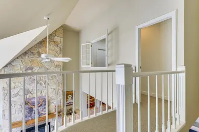 a staircase in a home with a stone wall at Walk to Ski Lift Spacious Condo in West Dover! in West Dover