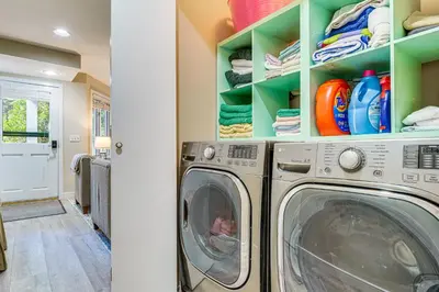 a washing machine in a laundry room with green shelves at Walk to Ski Lift Spacious Condo in West Dover! in West Dover