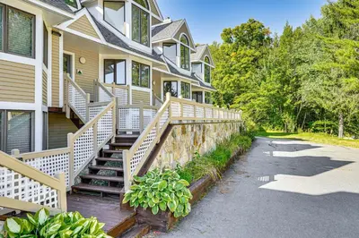 a house with a stone retaining wall and stairs at Walk to Ski Lift Spacious Condo in West Dover! in West Dover