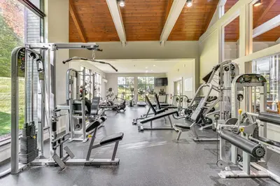 a gym with treadmills and cardio equipment in a building at Walk to Ski Lift Spacious Condo in West Dover! in West Dover