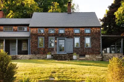 a brick house with a lawn in front of it at Stylish Rural Sanctuary Perfect for Every Season! in East Chatham