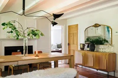 a dining room with a table and a mirror at Stylish Rural Sanctuary Perfect for Every Season! in East Chatham