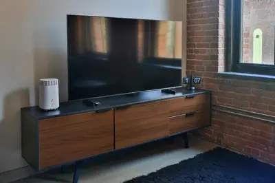 a large flat screen tv sitting on top of a dresser at The Othello - Luxury Industrial Loft near NYC in Communipaw