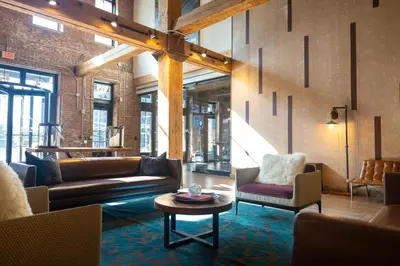 a living room with couches and chairs and a table at The Othello - Luxury Industrial Loft near NYC in Communipaw