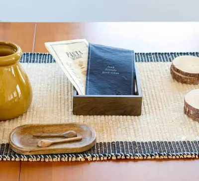 a wooden spoon sitting next to a book and a vase at Relaxing Hudson Valley Getaway- 4BR Sauna 15 acres in Stone Ridge